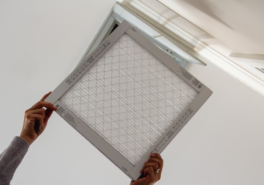 homeowner woman changing home air conditioning filter